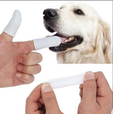Finger toothbrush cleaning a dog's teeth, pet dental care tool demonstration