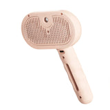 Pink pet grooming brush with ergonomic handle and metal bristles on white background